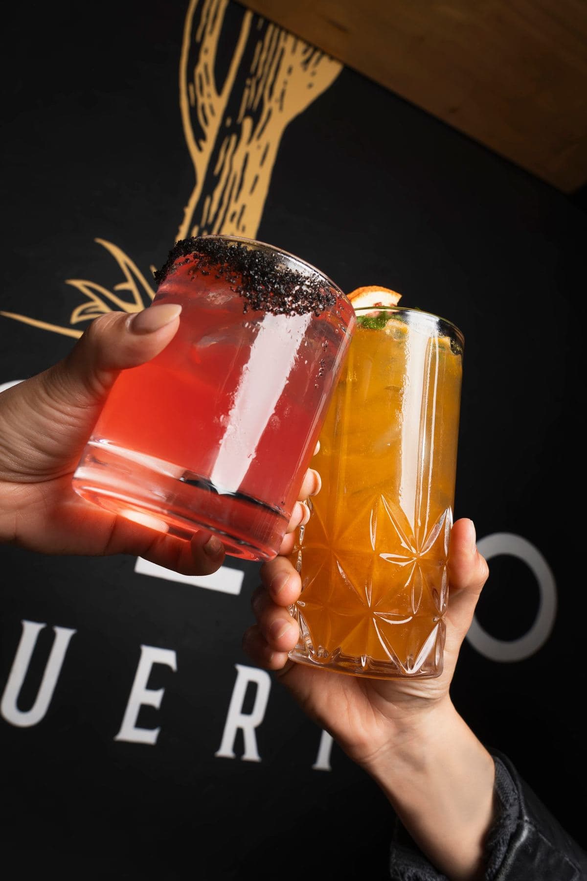 Two cocktails raised for a toast