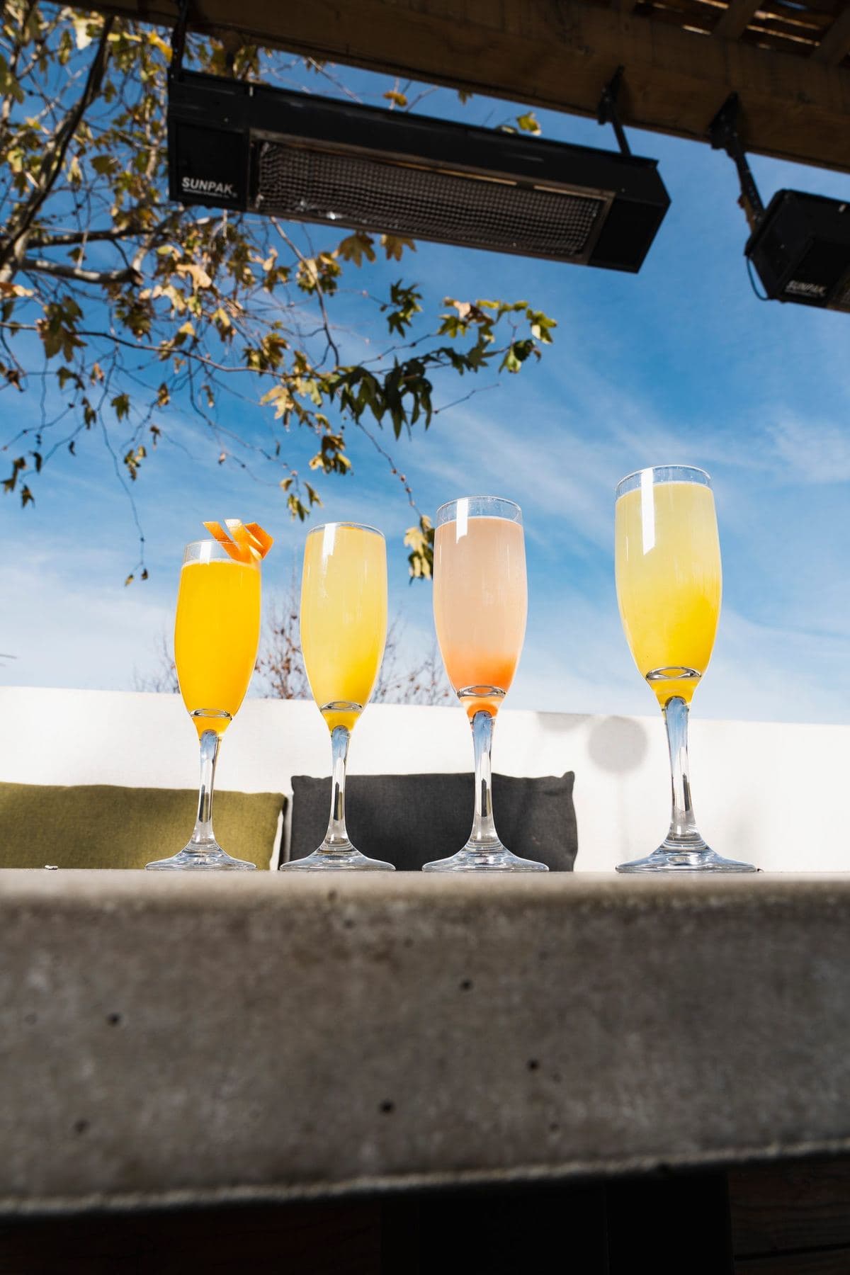 Row of bright cocktails on the sunny patio