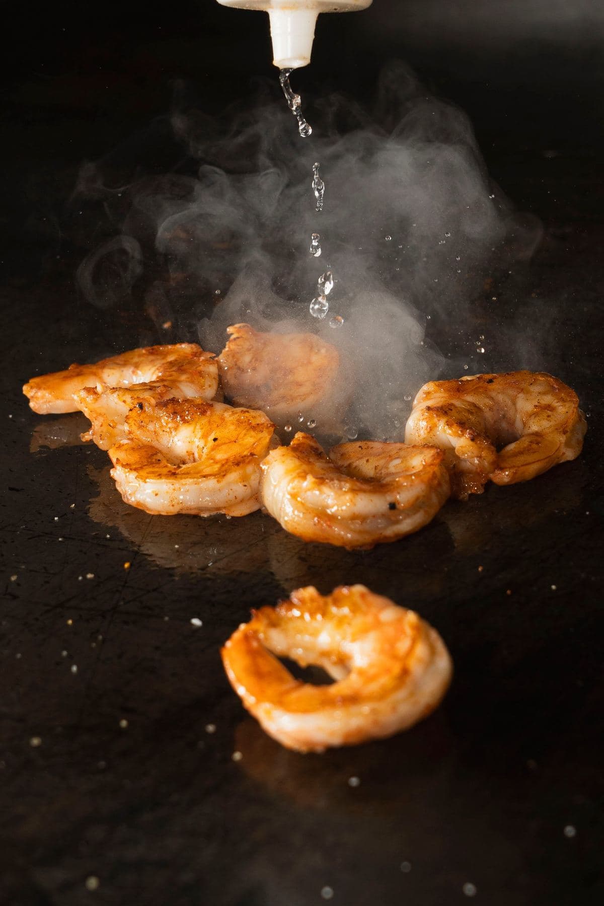 Shrimp searing on the flat-top grill