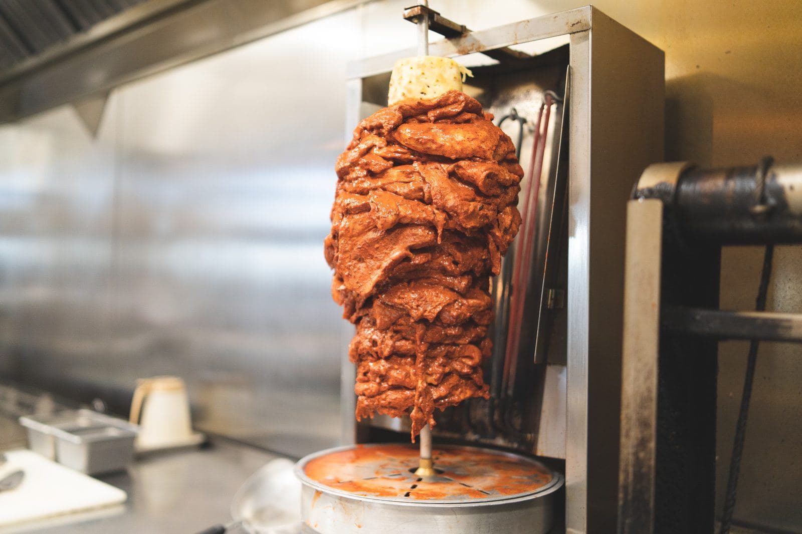 Al pastor pork roasting on the vertical trompo in Casero's kitchen