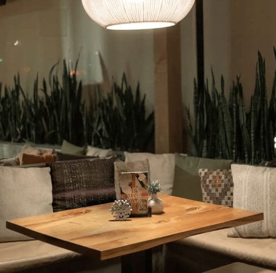 Lounge booth seating surrounded by plants