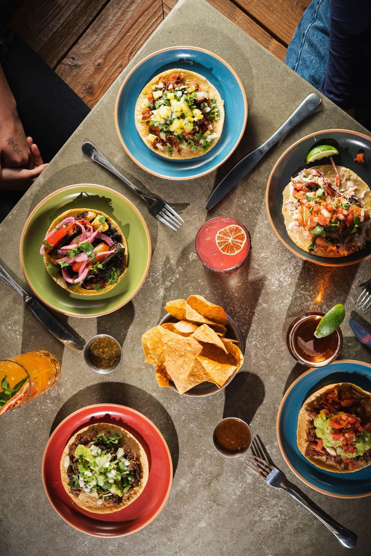 Overhead taco feast with chips, salsa and colorful plates